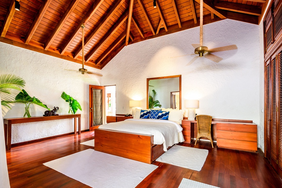 The guest bedroom with high ceilings and stylish decor.