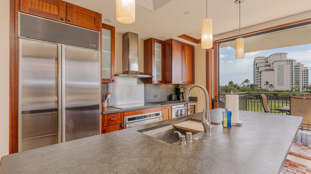There is a fully equipped kitchen with stainless steel appliances.