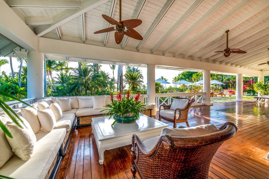 Open-air lounge area with comfortable seating and lush greenery.