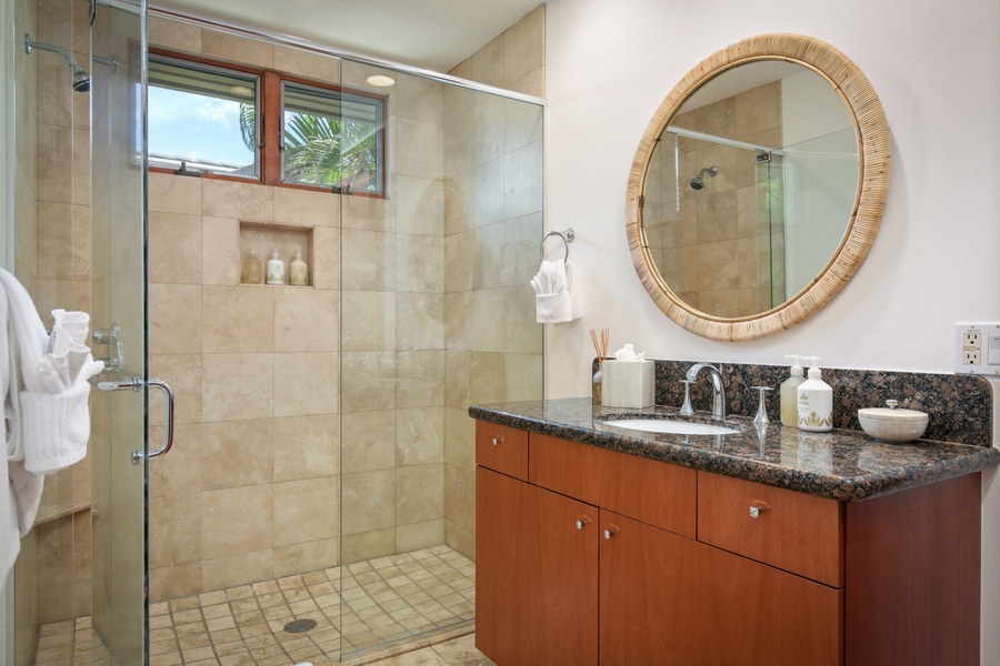 Guest Suite #3’s dedicated full bath with large glass enclosed shower.
