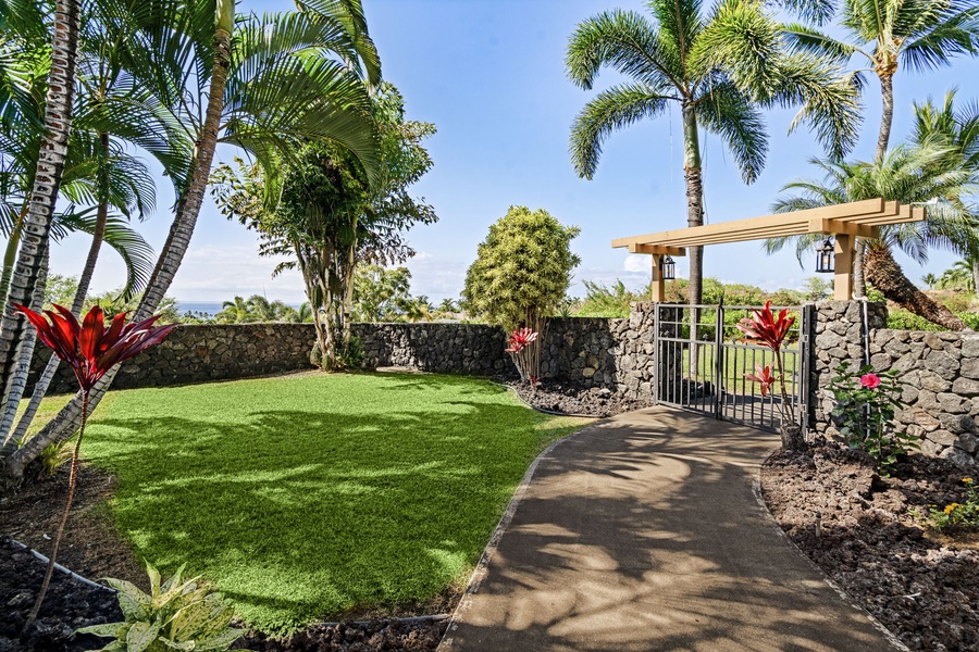 Tropical garden pathway leading to your private oasis with vibrant greenery.