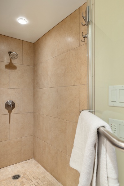 The walk-in shower with a glass enclosure.