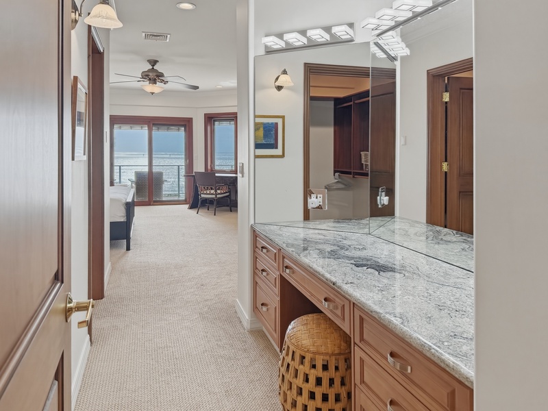 Features elegant marble countertops and stunning ocean views, creating a serene spa-like retreat.