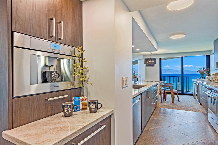 Enjoy your morning coffee with a stunning ocean view from this sleek, fully equipped kitchen.