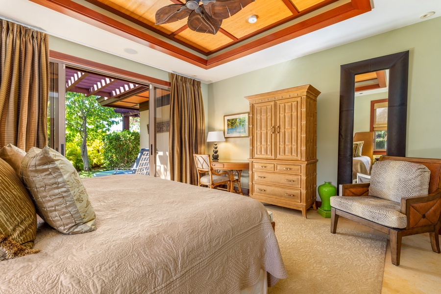 Guest Bedroom 2 features vaulted ceilings, a king bed, and direct access to a peaceful garden lanai.