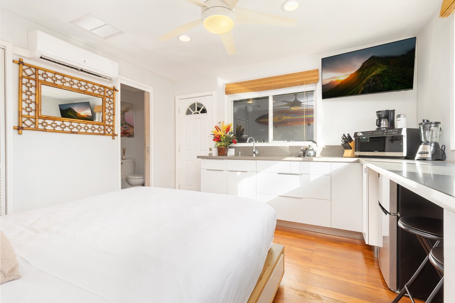 Studio layout with smart design—enjoy a comfortable king bed, ceiling fan, and access to your own kitchenette.