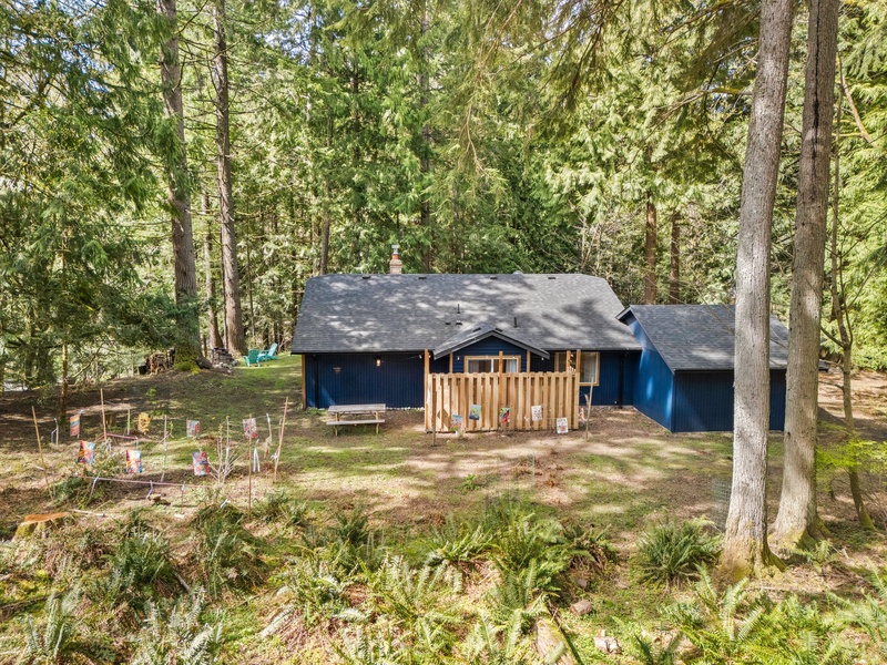 Tucked into the woods, the home blends naturally into its surroundings for ultimate relaxation.