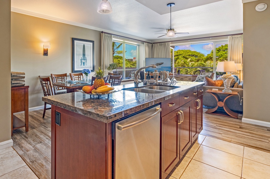 A stylish island anchors the open-concept layout of Honua Kai Konea 230/232’s kitchen and living space