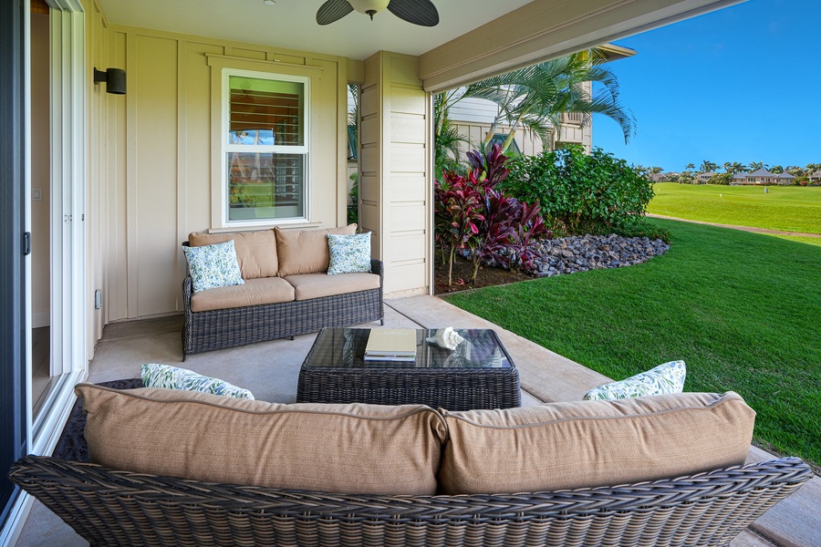 Your private lanai features plush seating where you can unwind with tropical garden views stretching across manicured greens.