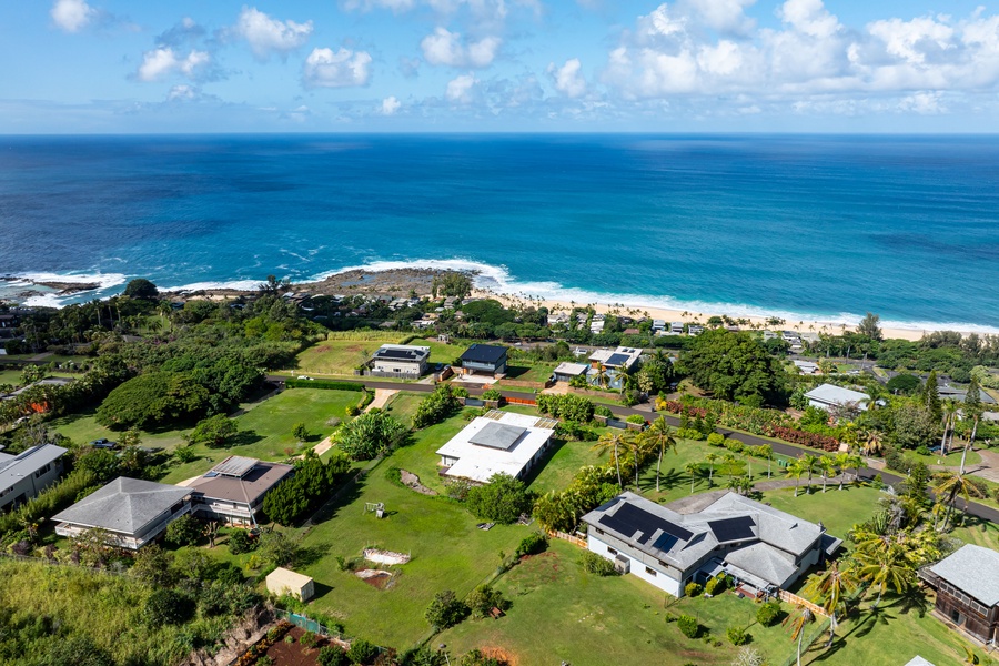 Stunning aerial view showcases the vibrant green surroundings and coastal proximity.