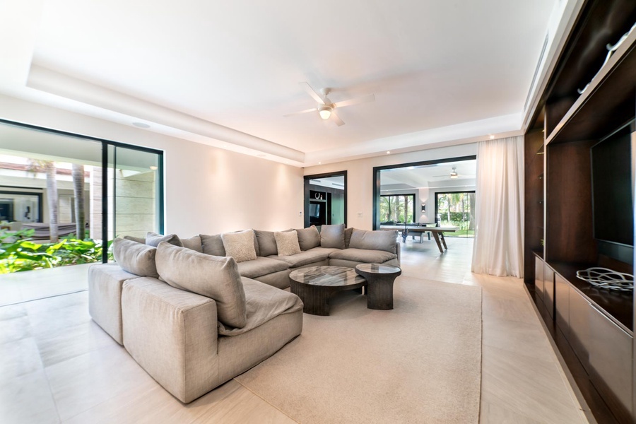 Unwind in this cozy lounge area featuring a plush sectional sofa and open views to the rest of the home.