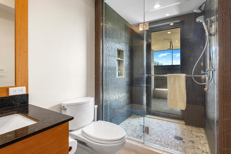 Freshen up in the guest bath featuring a large walk-in shower.