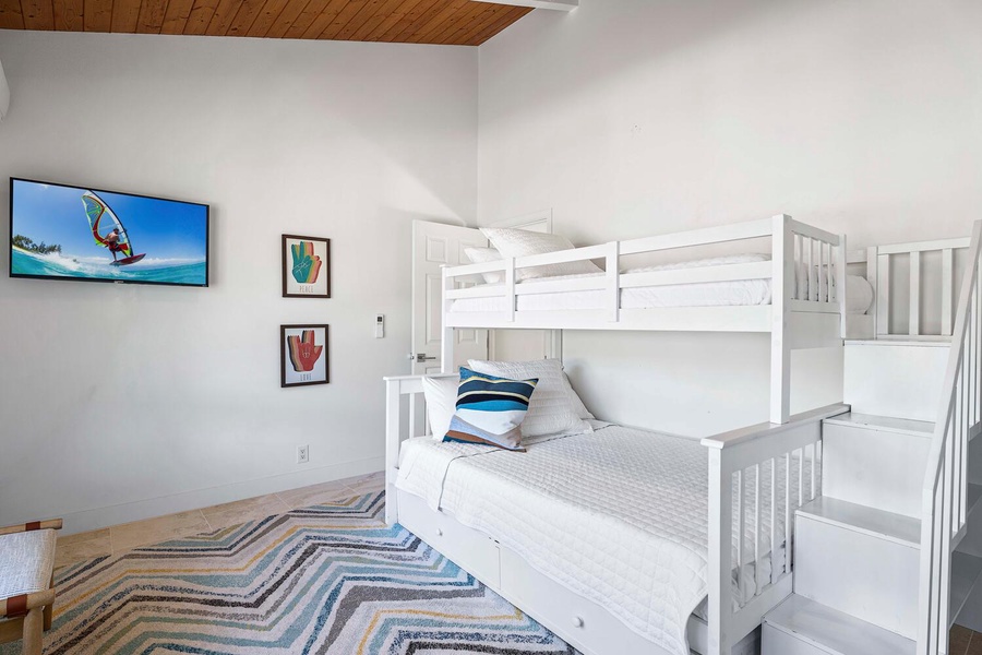 Cheerful and airy bunk room, where vibrant art and crisp linens create a playful yet restful space for dreams and adventures.
