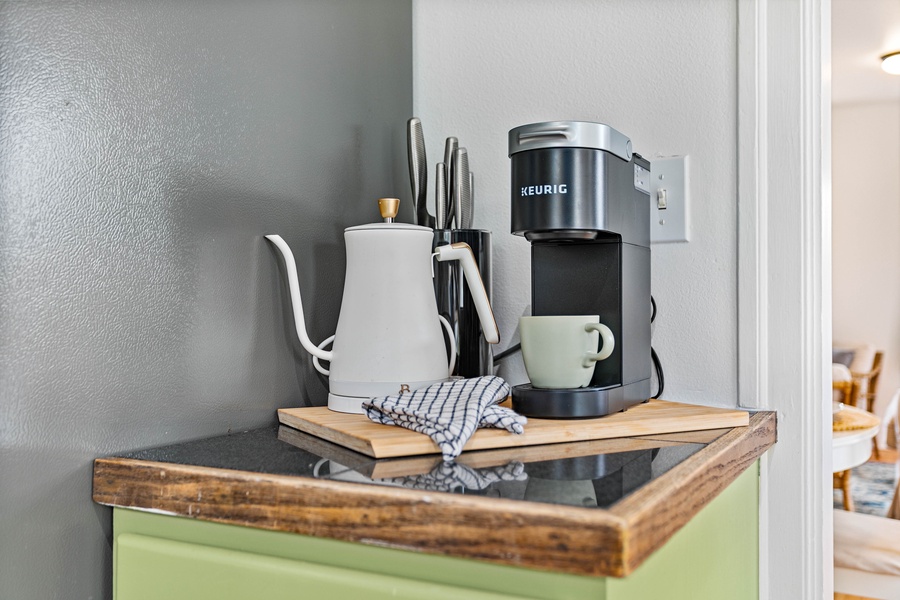 This beverage nook combines convenience with style—featuring a French press, electric kettle, and rustic wood detail.