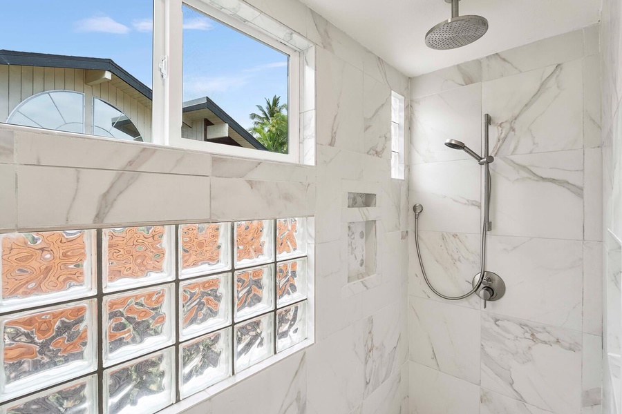 The separate shower has natural lighting.