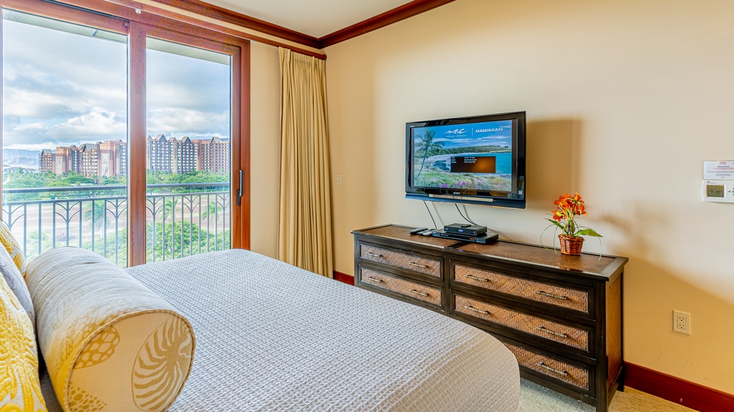 The primary guest bedroom also has a TV, dresser and luxurious linens.