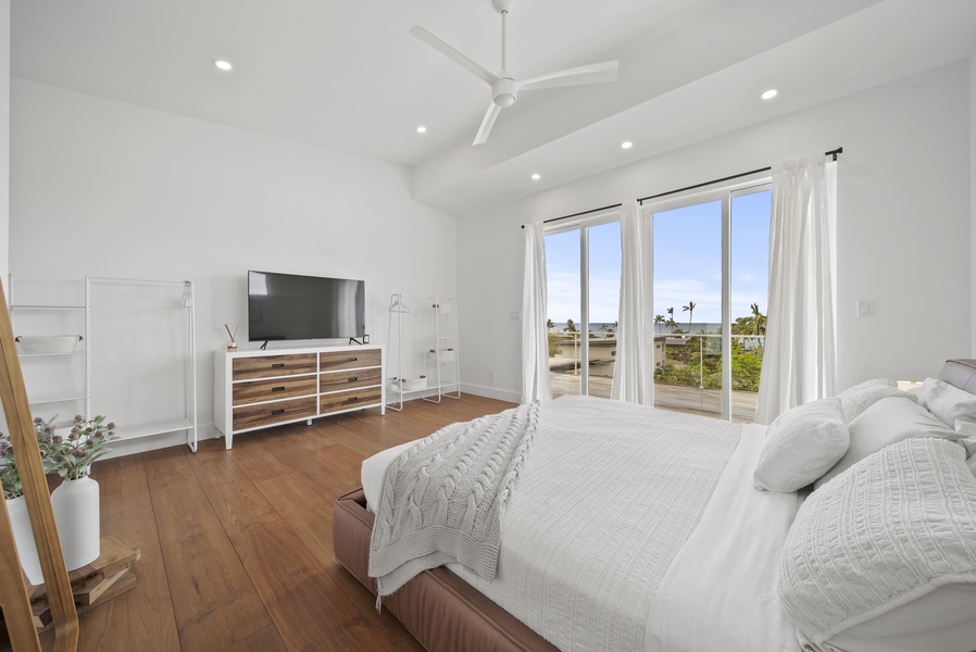 Bright and airy suite has a king-sized bed, large glass sliders and direct access to the lanai.