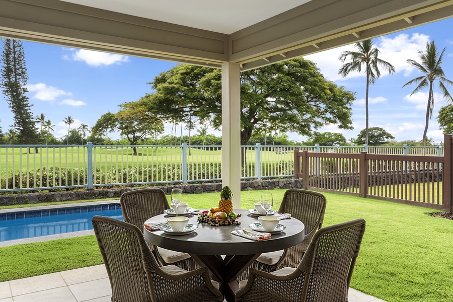 Lanai with dining table overlooking the pool and the Golf Course