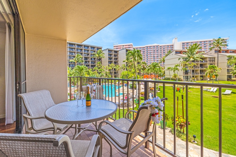 Enjoy a drink on the lanai at Kaanapali Shores 213, with views of the pool and lush scenery.