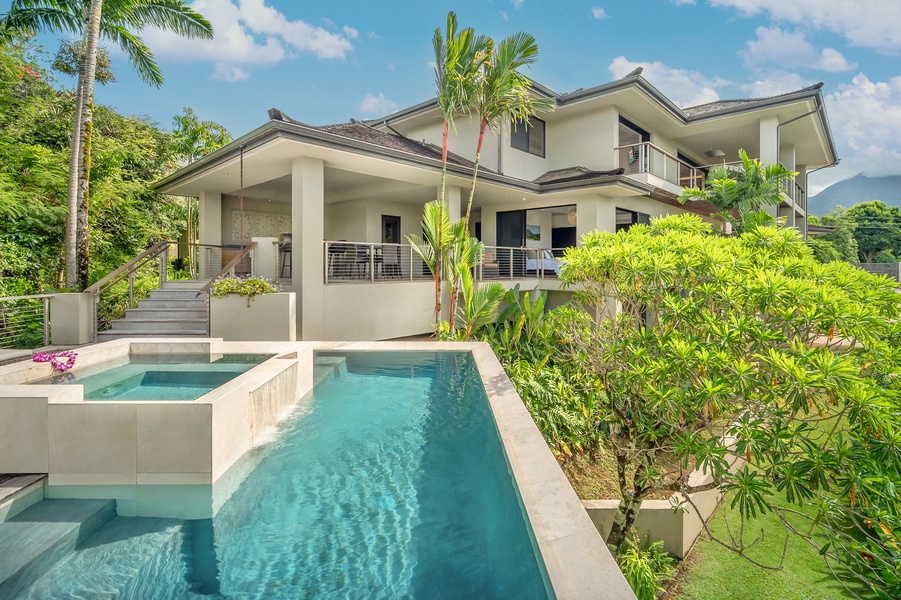 Modern pool area with seamless design connecting to the villa’s elegant exterior, surrounded by tropical greenery.