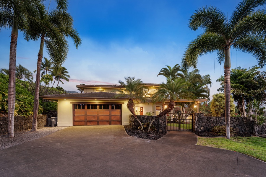 Evening view of the beautifully lit home, exuding warmth and sophisticated charm.