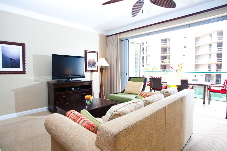 The living room is a bright and inviting space, featuring comfortable seating and a flat-screen TV for entertainment.