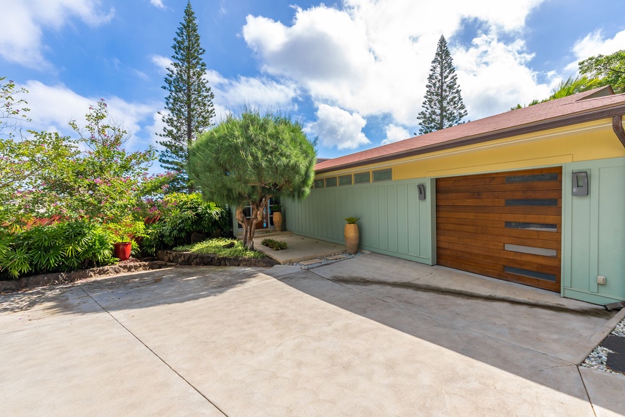 Spacious driveway with attached garage and modern exterior design.