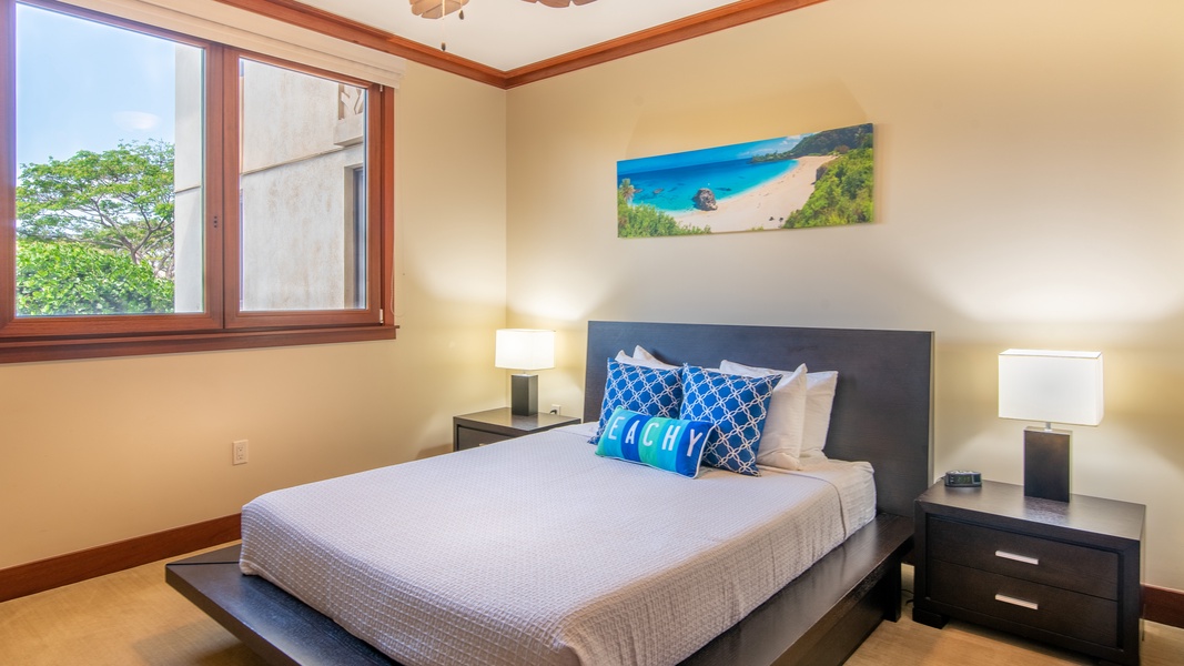 The second bedroom with a queen size platform bed and vibrant art.