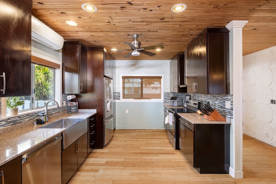 This chef-ready kitchen features sleek wood cabinetry, granite counters, and dual sinks—set up for prepping large meals with ease.