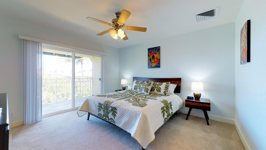 The primary guest bedroom with a king bed and lanai access upstairs.