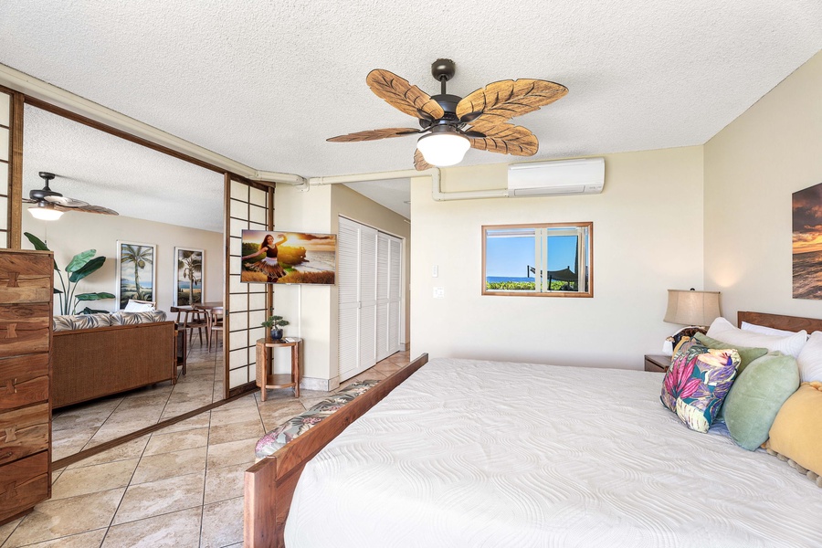Cozy primary bedroom with cable TV, conveniently located next to the vibrant living area for easy relaxation and entertainment.