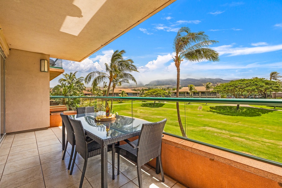 The outdoor dining area on the lanai offers breathtaking views of the lush landscape and swaying palms