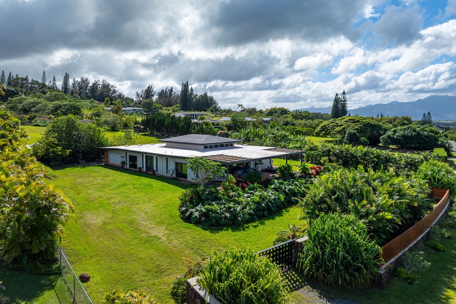 A cozy home surrounded by greenery offers peaceful outdoor spaces.