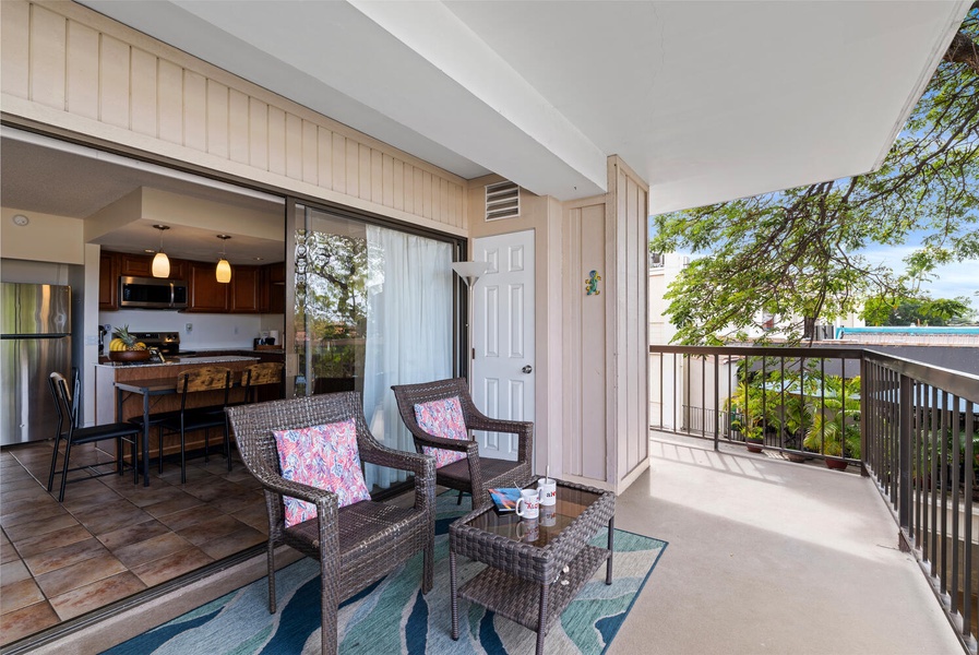 Step onto your private lanai where wicker chairs invite you to unwind with morning coffee while taking in peaceful neighborhood views.