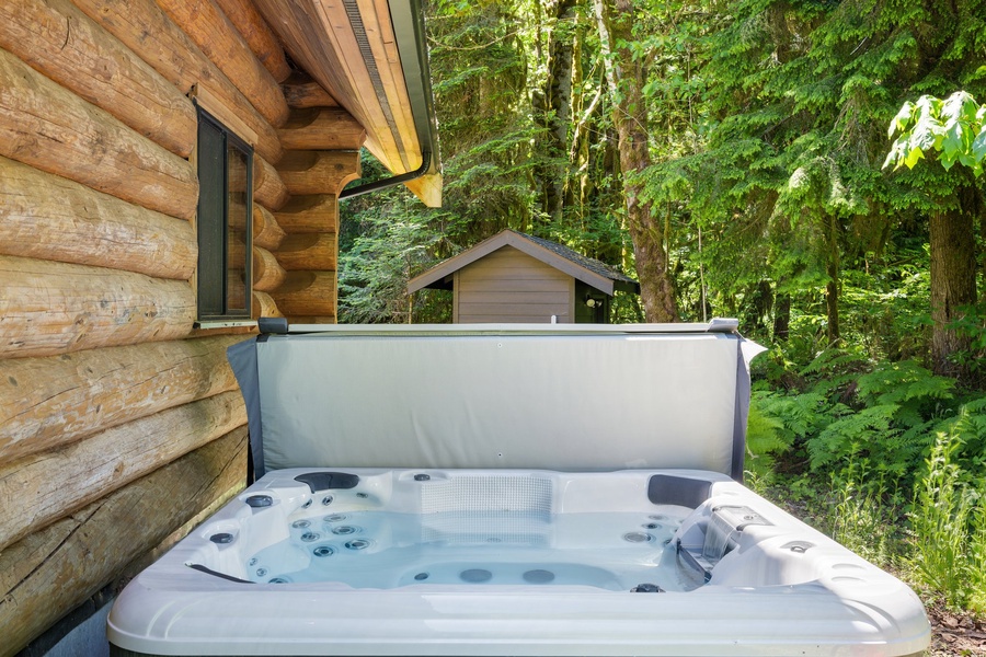 Step into the inviting warmth of our outdoor hot tub, a tranquil oasis under the open sky.
