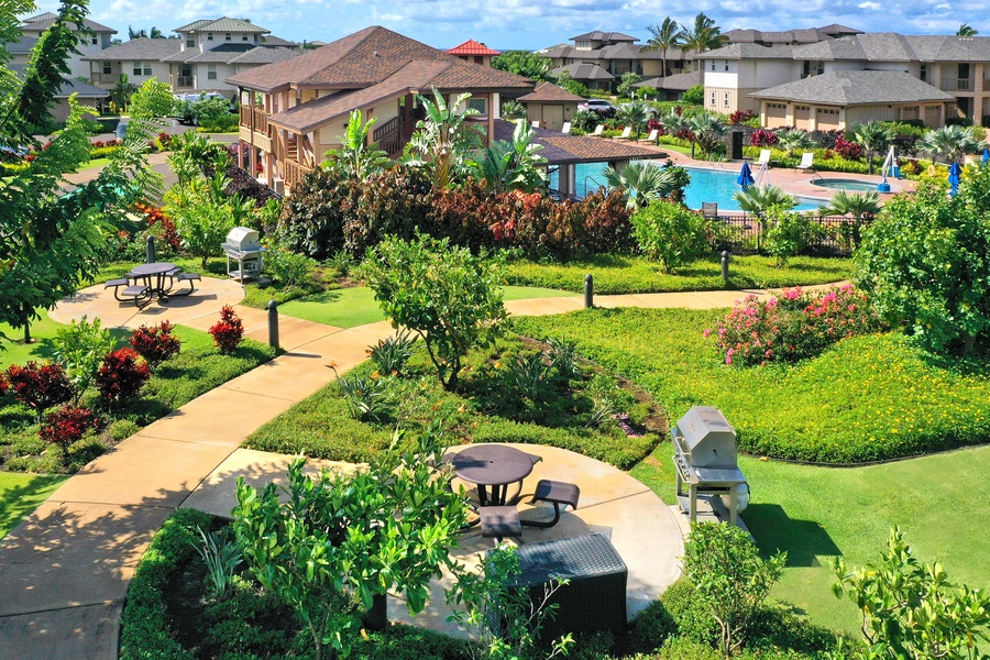 Relax in lush gardens with shaded seating and tropical views.