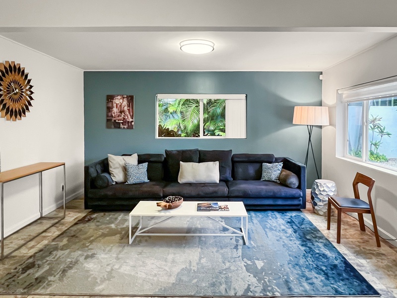 Spacious formal living area with a modern touch and plush seating, ideal for entertaining.