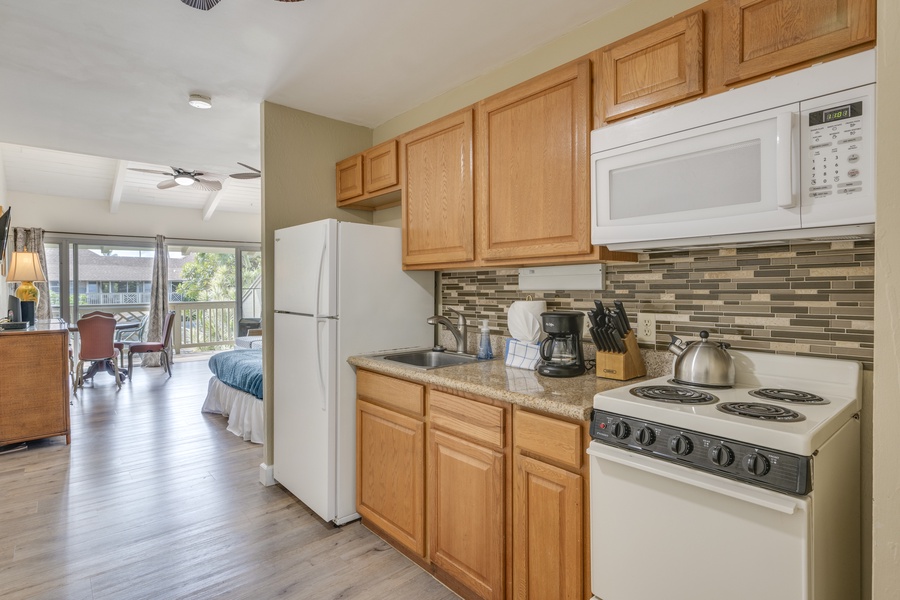 Your fully equipped kitchen features warm wood cabinets, granite counters, and modern appliances—perfect for preparing meals during your stay.