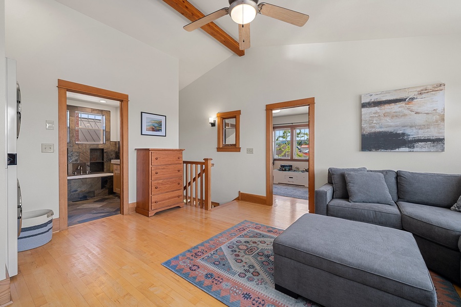 The upstairs lounge area in the home is a perfect place to unwind, offering a more secluded spot for relaxation.