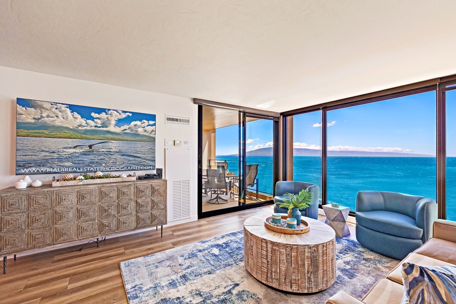 Unwind in this modern living room with floor-to-ceiling windows that offer stunning panoramic ocean views