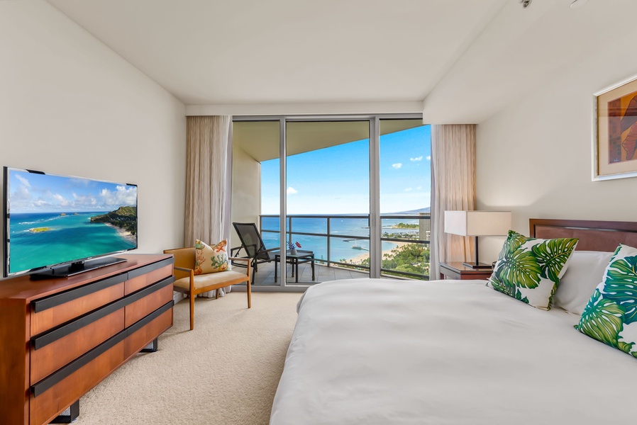 Wake up to breathtaking ocean views from the comfort of this serene bedroom.