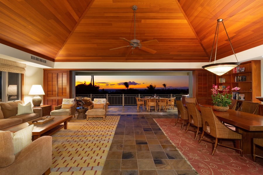 View from upper landing entry across great room to lanai and sunset beyond.