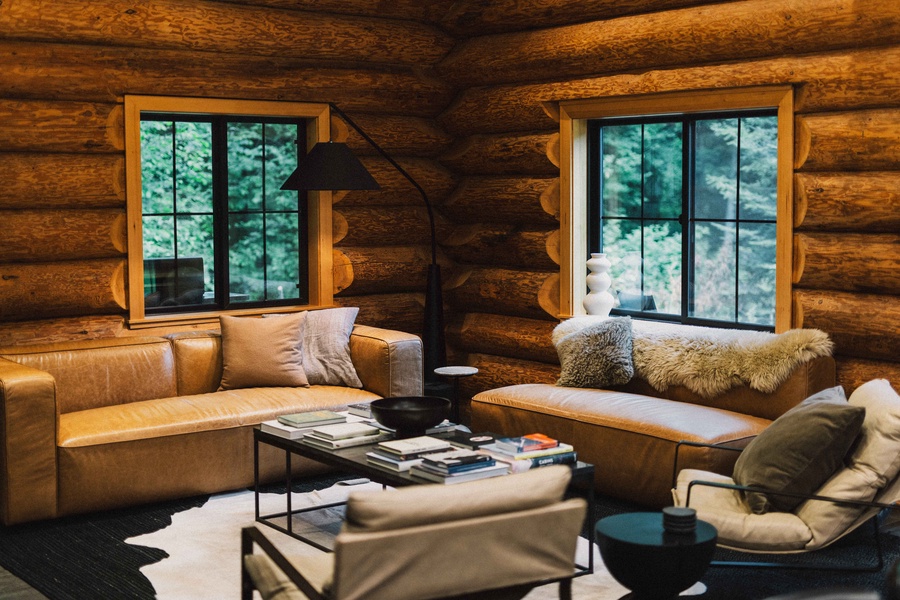 Relax on plush seating surrounded by forest views and handcrafted log interiors.