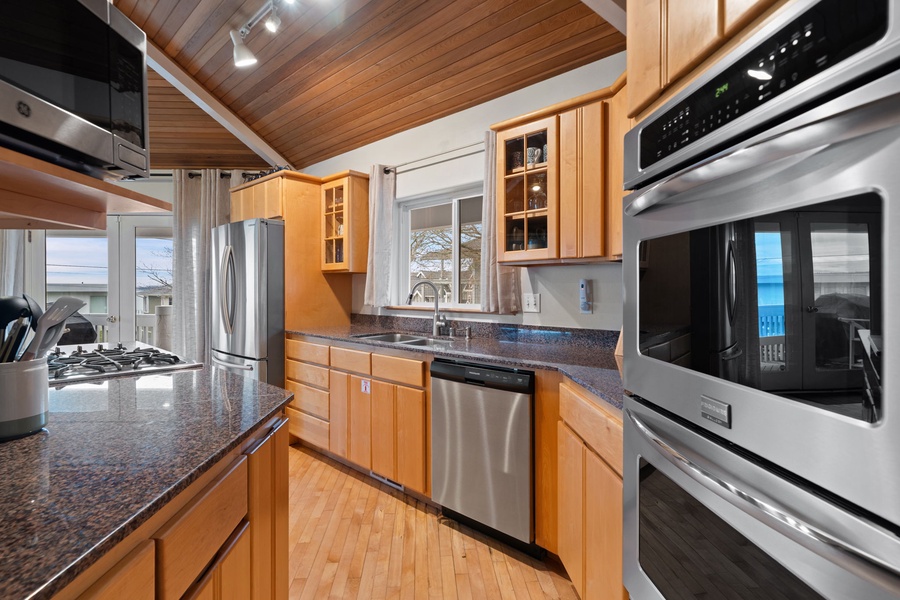 Your gourmet kitchen features granite countertops, stainless steel appliances, and warm wood cabinets perfect for creating memorable meals.