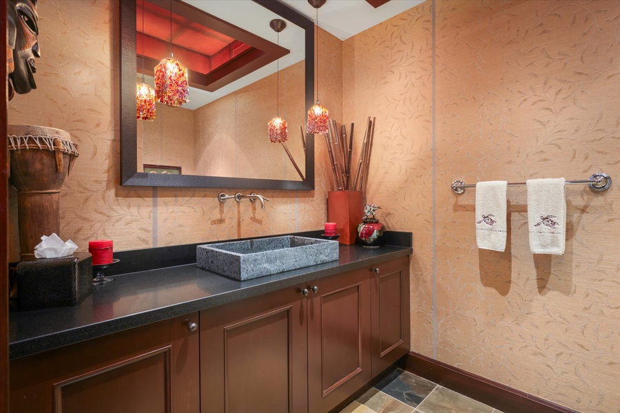 Powder room with dramatic lighting and artistic finishes—perfect blend of form and function.
