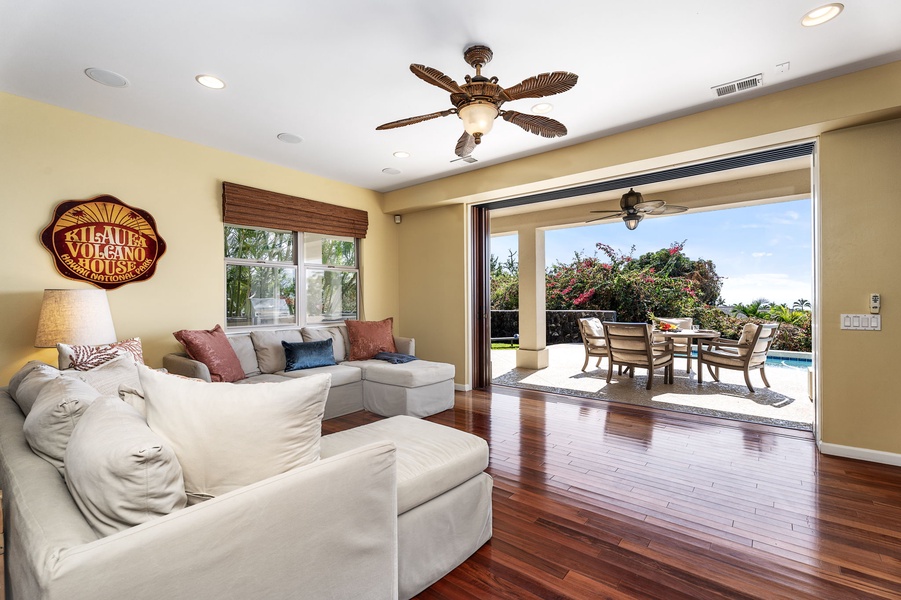 Spacious family room with large windows framing serene outdoor views.