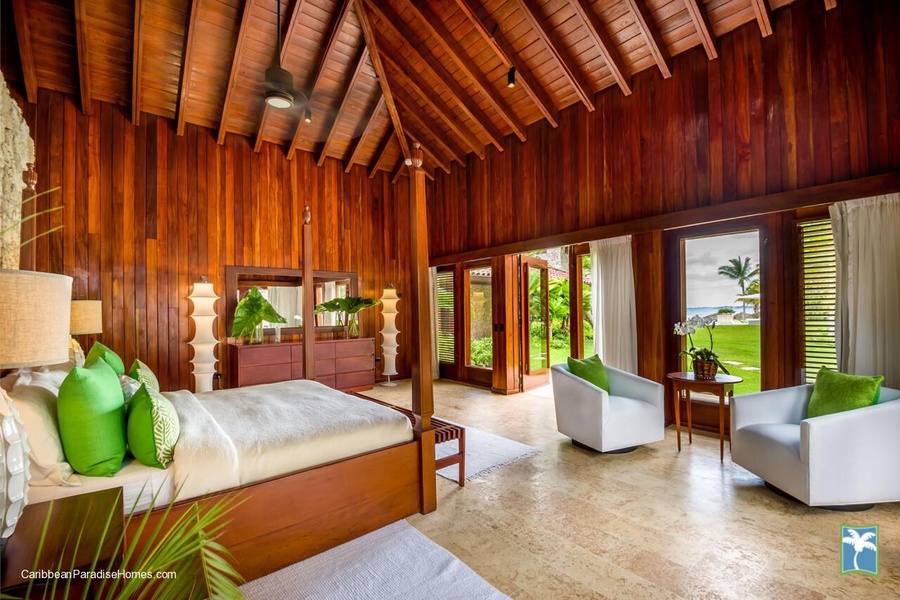 Guest bedroom with a garden view and comfortable seating area.