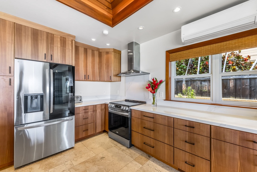 Modern kitchen with stainless steel appliances and rich wood cabinetry—fully equipped for your culinary adventures.