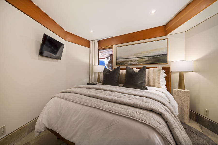 Cozy bedroom with luxurious linens and nautical artwork creating your perfect retreat.