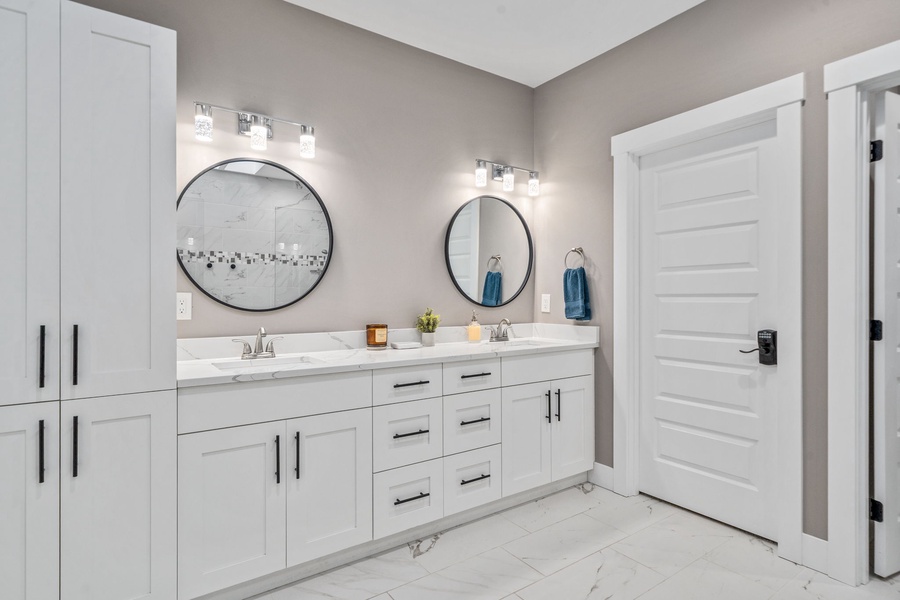 Features dual vanities with stylish round mirrors and abundant storage for all your essentials.
